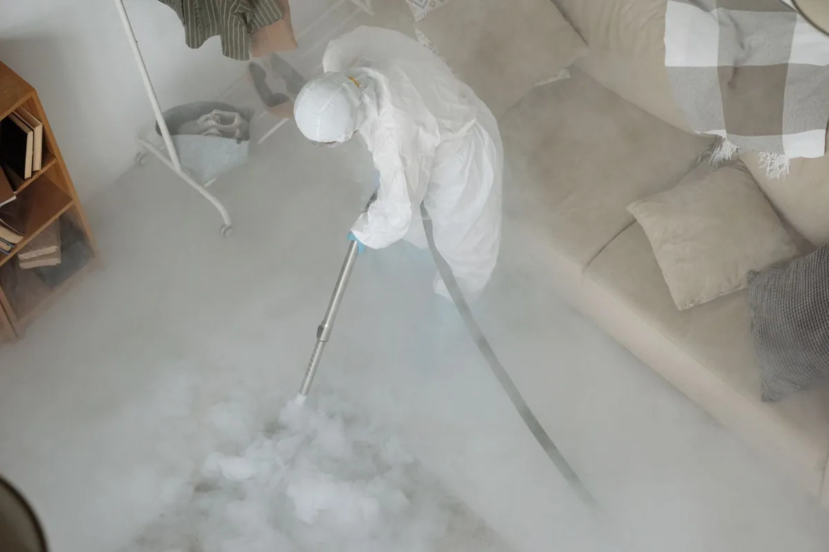 Biohazard cleanup technician in protective equipment, White Sands, NM